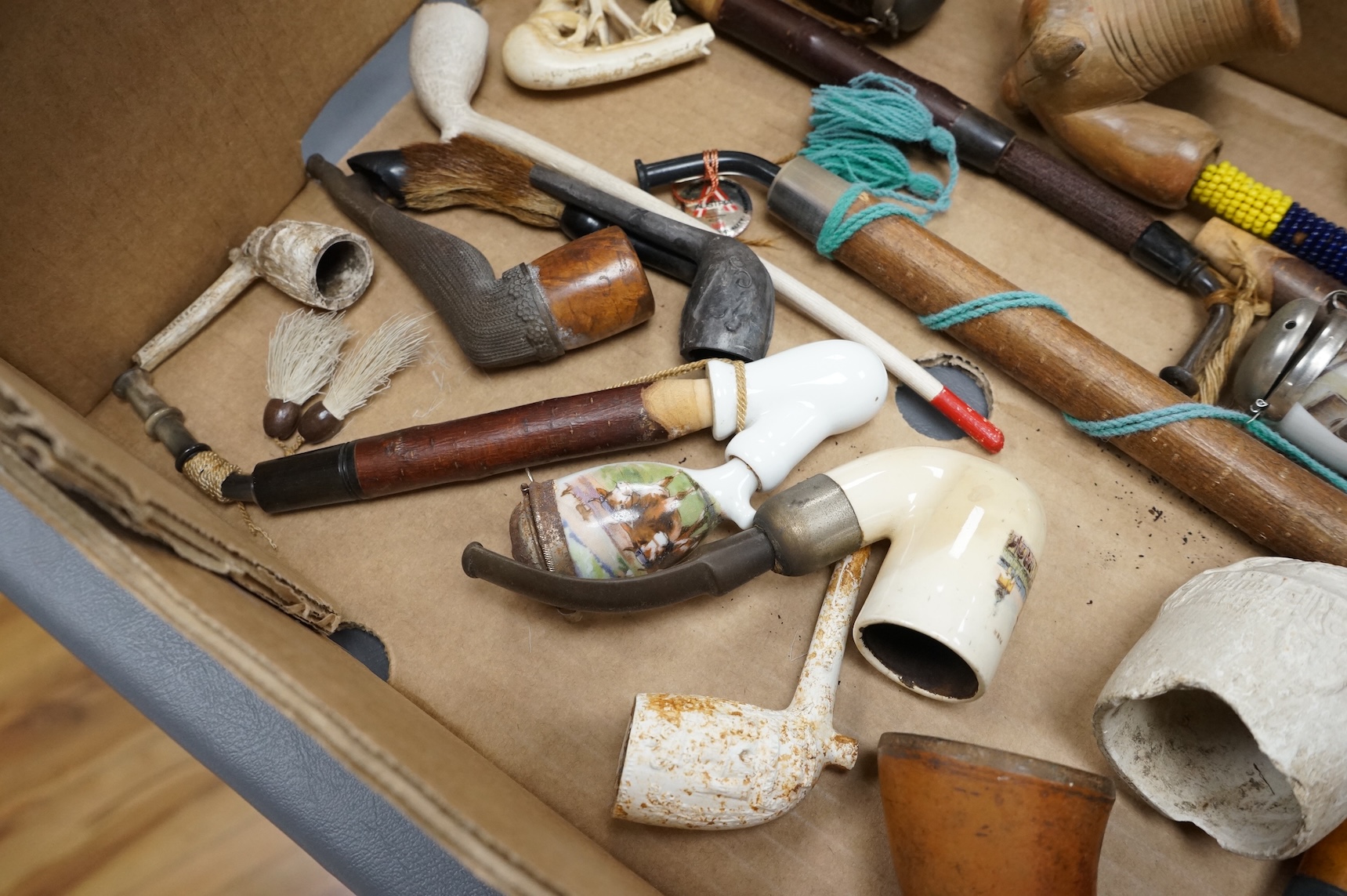 A group of fifteen novelty pipes to include treen, clay and ceramic examples